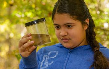 Girl holding jar