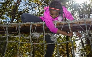 Girl climbing a rope